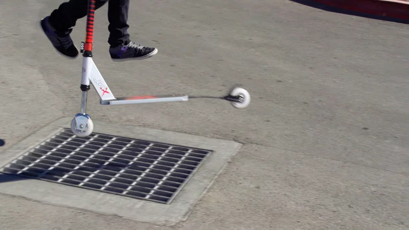 Performing a tail whip over a storm drain on the JumpX