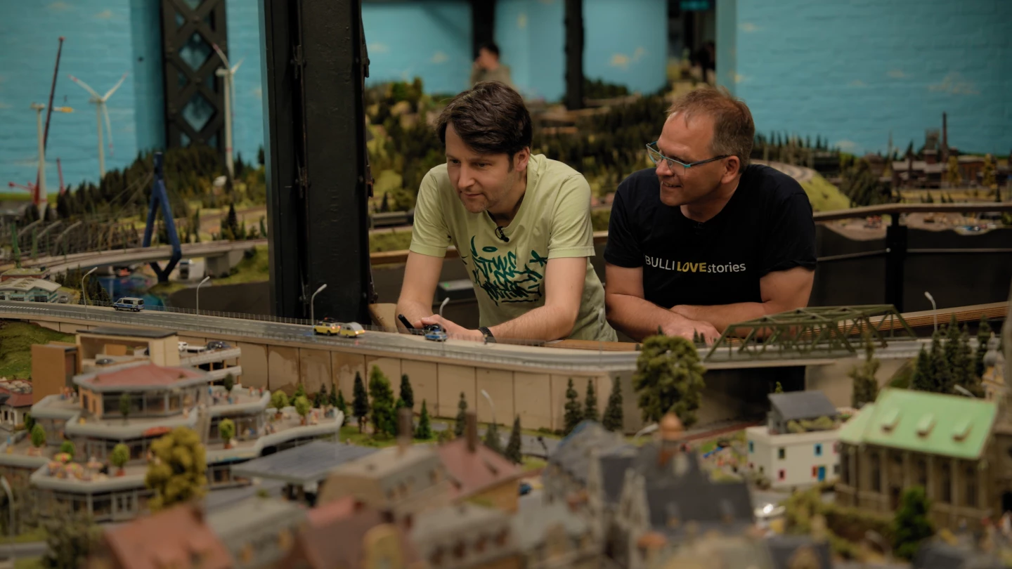 Christian Schlüter (right) and Miniatur Wunderland tech Axel Dirks watch the ID. Buzz makes it rounds in the grand model railroad and landscape at the unique Hamburg museum
