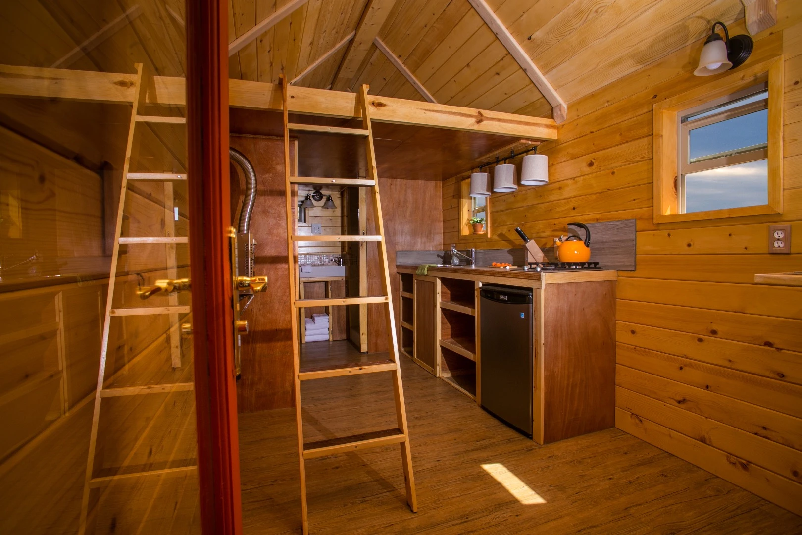 A ladder leads to a small loft sleeping area upstairs