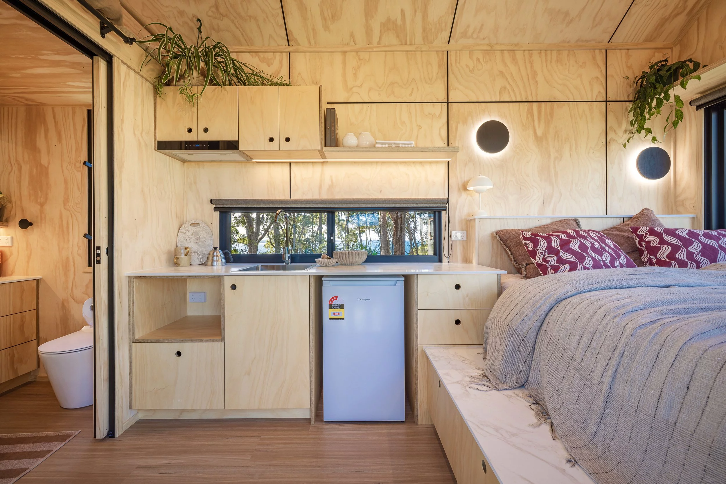 The Five Four's kitchen is relatively simple and includes an electric cooktop, a sink, and a small fridge