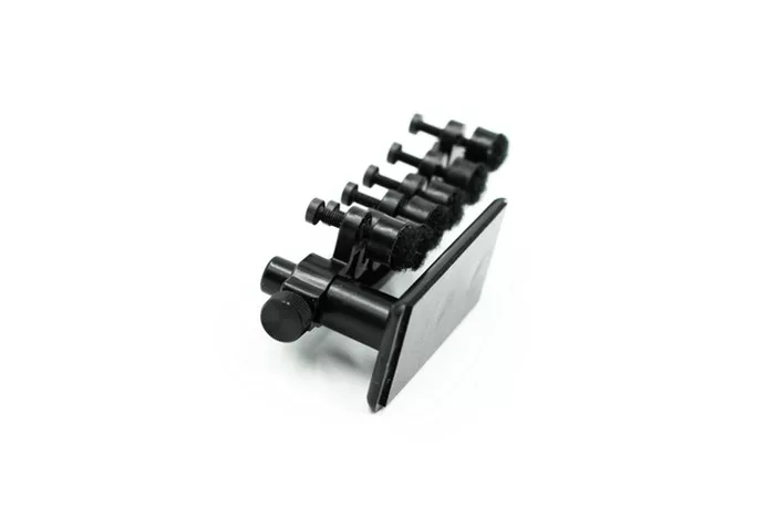 Guitar-Jo 2 has a mounting foot that's attached to an electric guitar's body, near the neck pickup, and a main arm that's home to six adjustable dampening pads