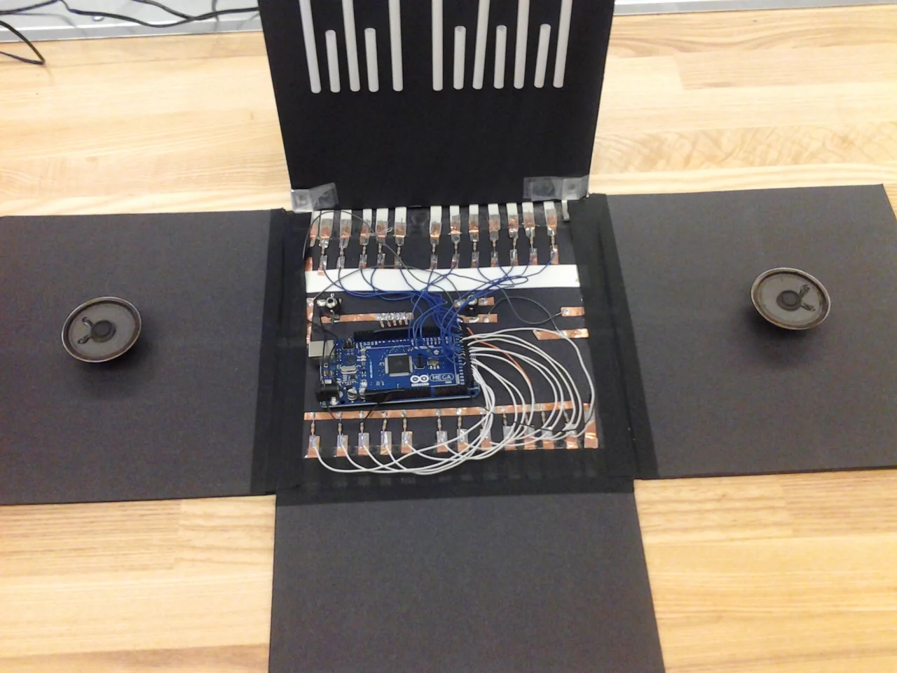 At the heart of the Piano Box is an Arduino Mega microcontroller running CapSense and Tone libraries - each touch key is mapped to its own LED light