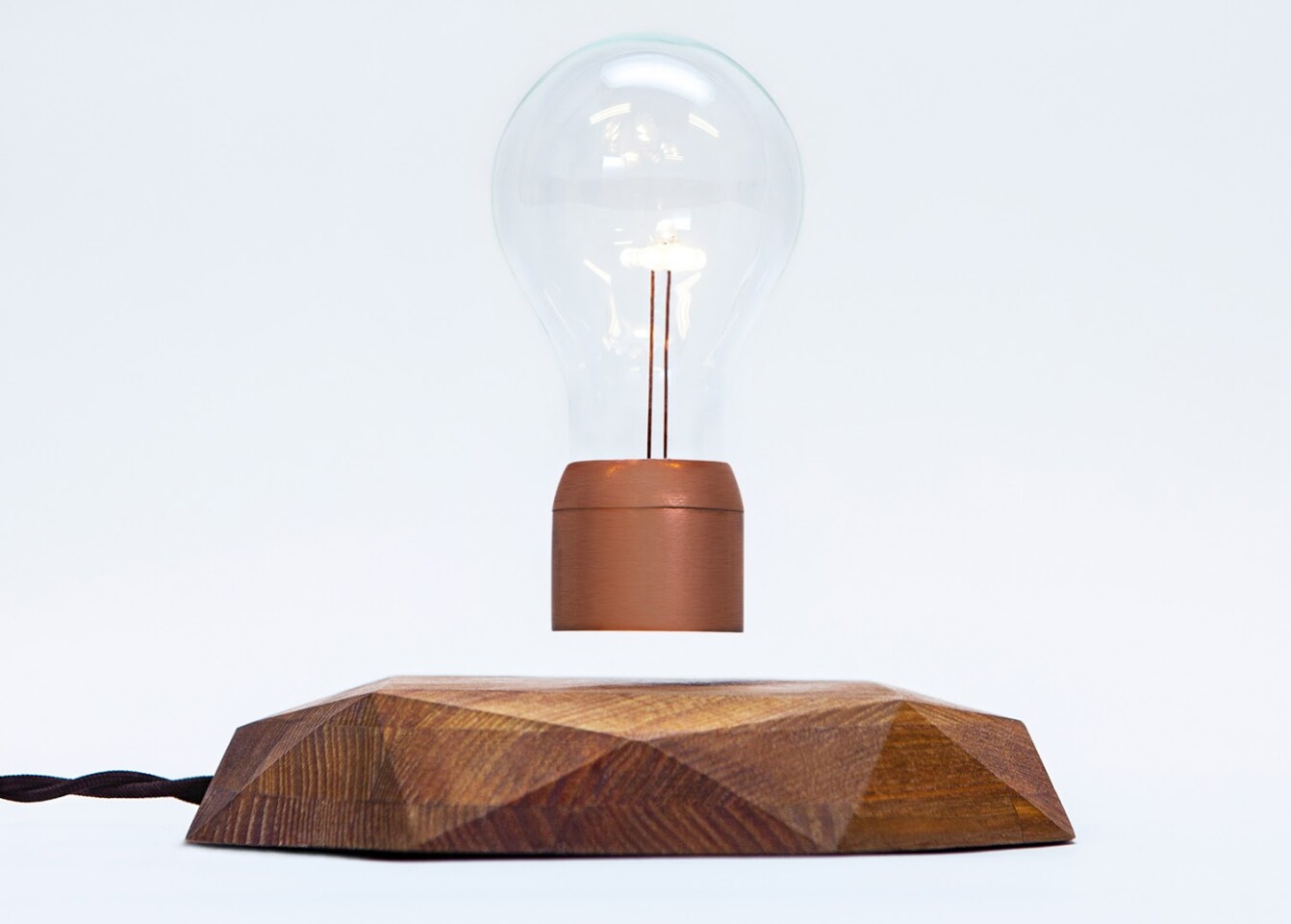 Placing the bulb on the base and releasing it slowly will see it rise and settle into position