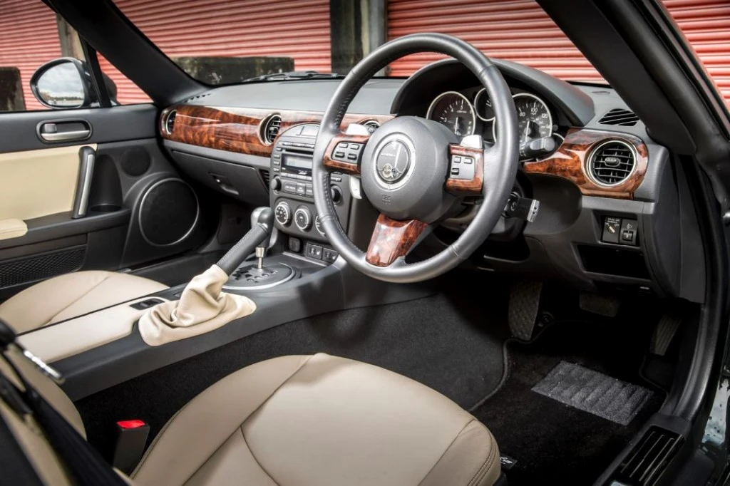 Woodgrain trim and beige leather can't hide the fact this is an MX-5 underneath