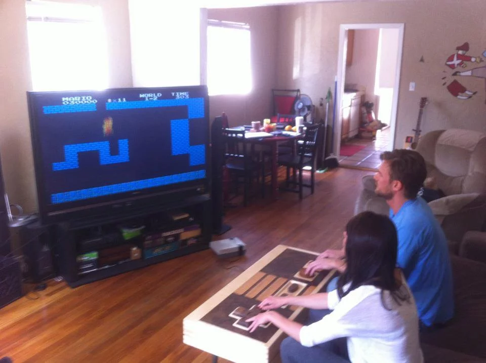 Charles Lushear controlling the action of an 8-bit classic using his coffee table