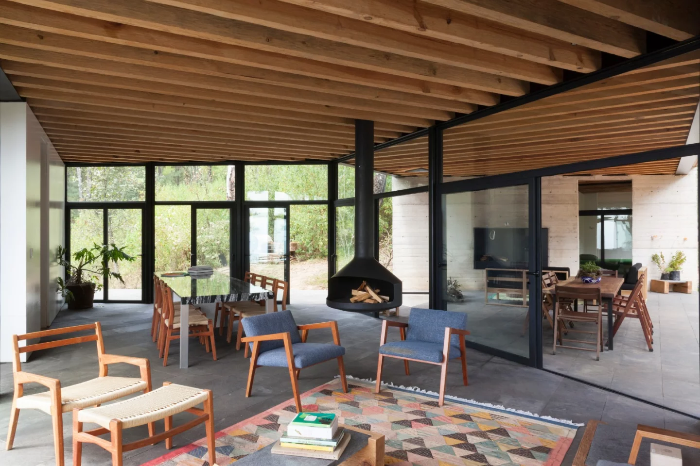The arms of the Casa de la Roca meet in the middle at a central node that is outdoors, yet protected from the elements by a roof and walls on either side