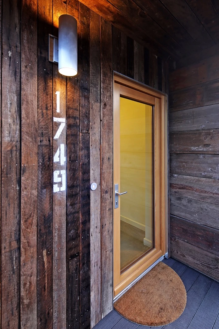 The building's insulation and its wood-framed windows and doors are designed to create an airtight seal to minimize thermal and sound leaks