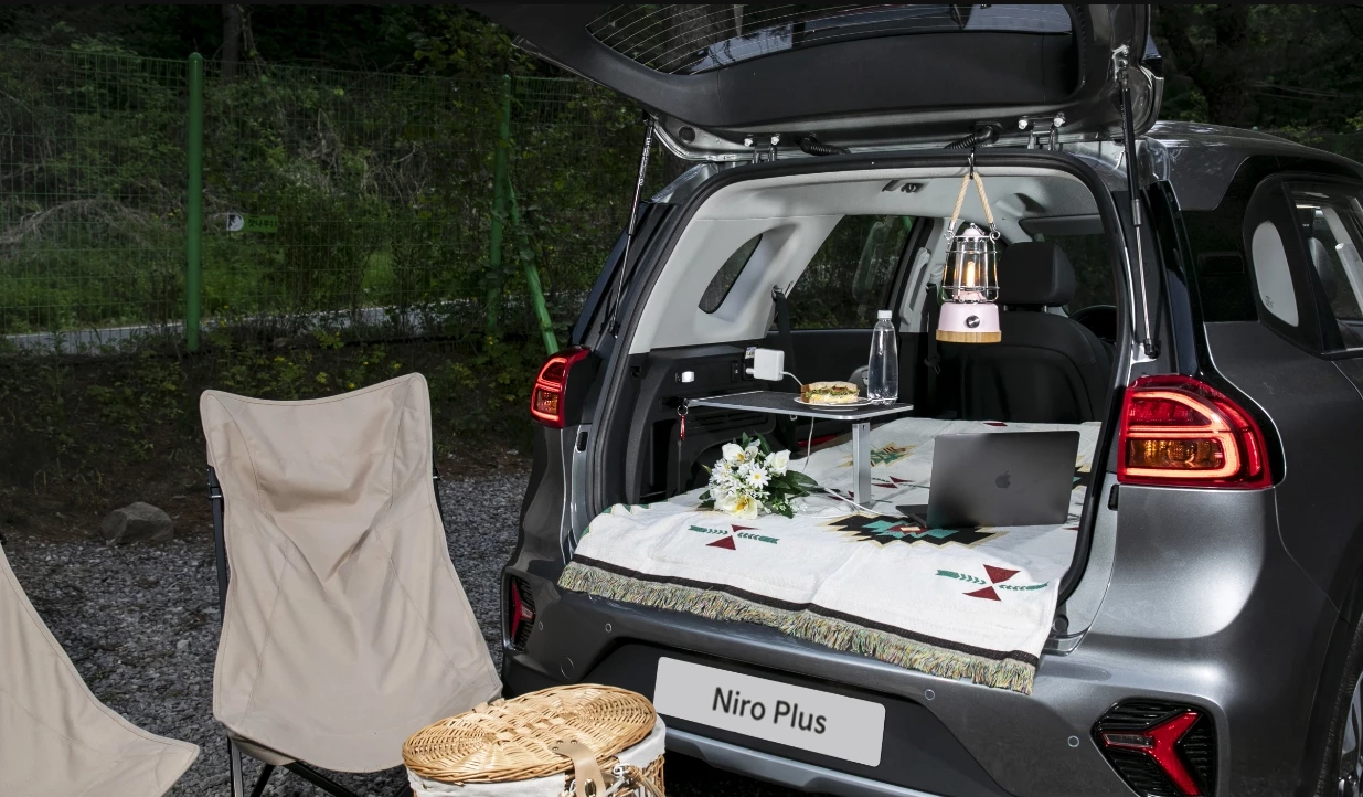 Kia accessorizes the Korean-market Niro Plus into an electric micro-camper and picnic in the park