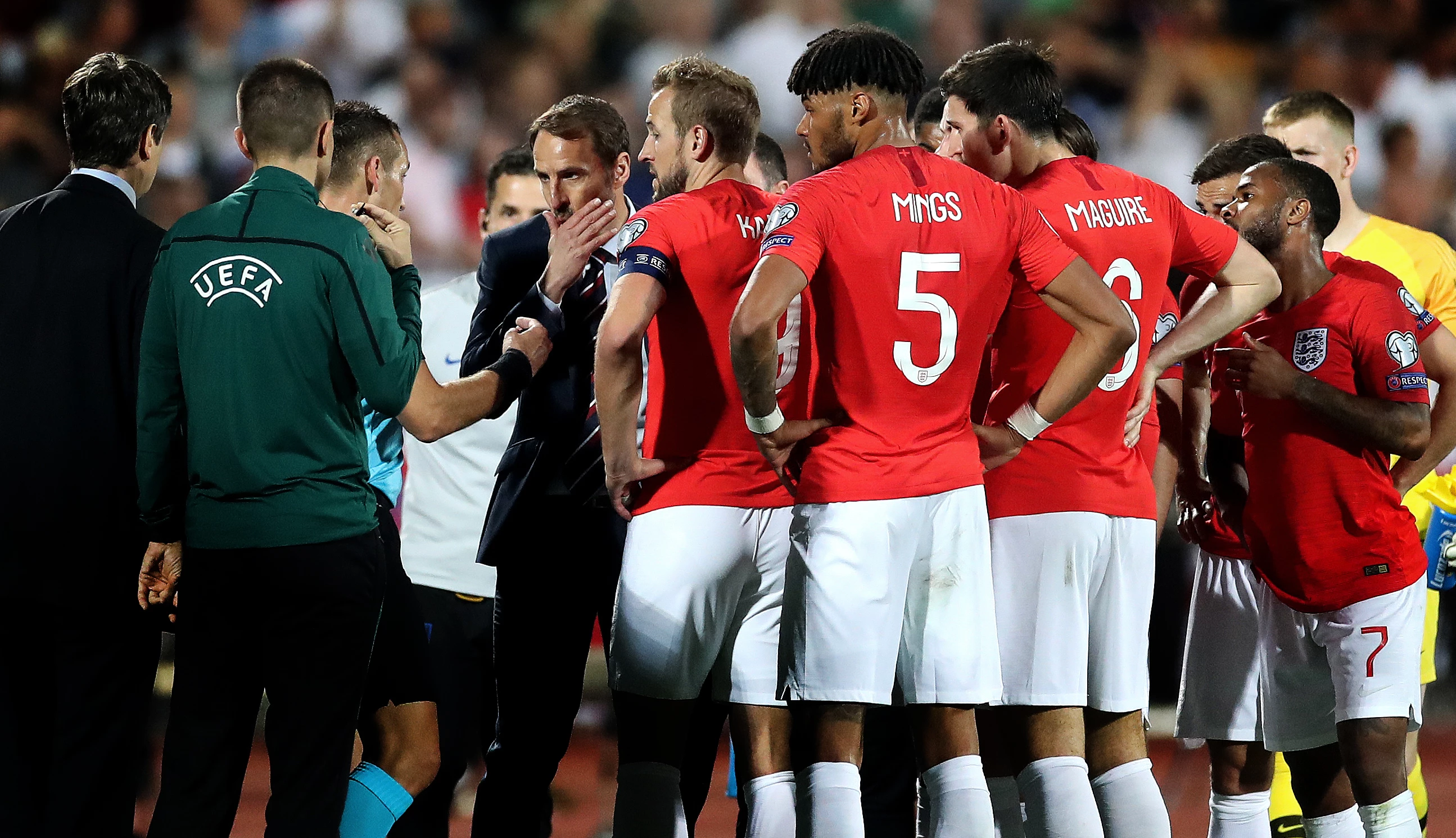 Bronze, Focus. The England players and manager Gareth Southgate speak to referee Ivan Bebek as the match is stopped during the first half