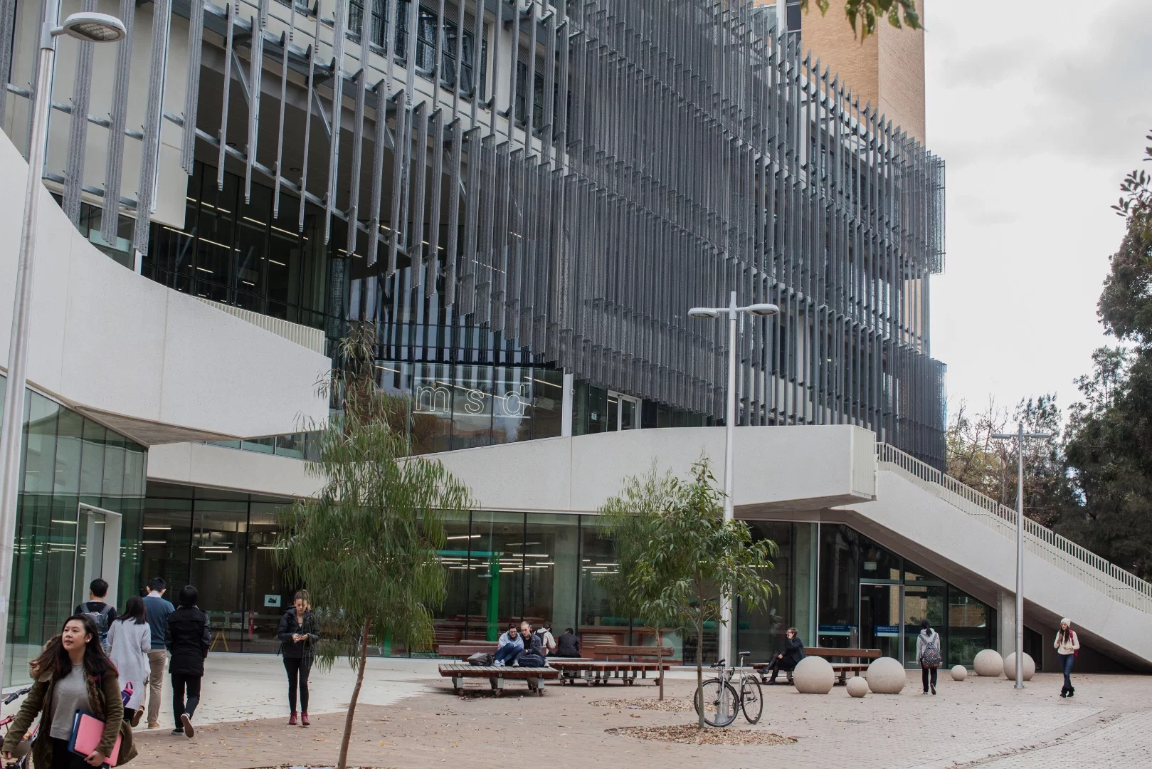 Perforated zinc sunshades shield the north, east and west sides of the building, resting a foot or so out from the building's exterior
