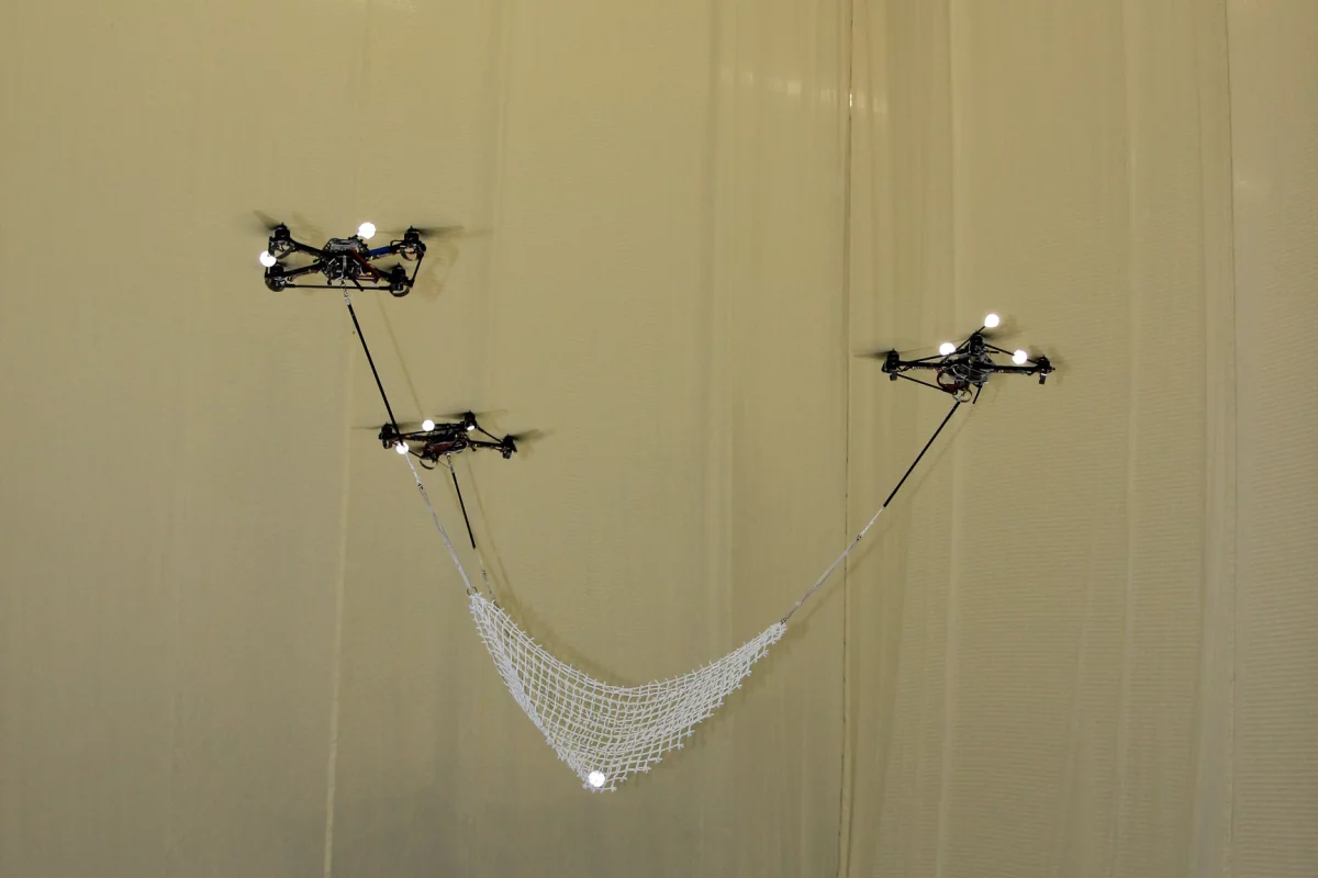 Flying quadrocopters at ETH Zurich's Flying Machine Arena catch and launch a ball using a net spread between them