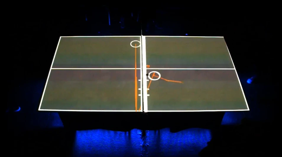 Pingtime augments an ordinary table tennis table with projections and sounds by equipping the paddles with sensors and using an infrared camera to track the ball (Video still: videogram)