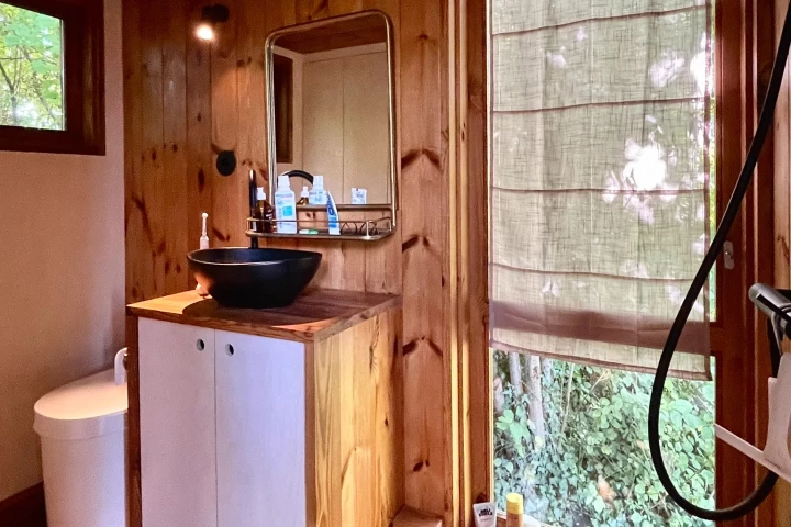 The Berra's bathroom includes its own separate door to the outside, as well as a composting toilet, sink, and shower