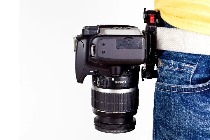 After attaching a plate to the bottom of a camera and then clamping the Capture Camera Clip's main chassis to a belt or bag strap, users can grab and shoot the DSLR as quick as a gunslinger from a cheesy Western