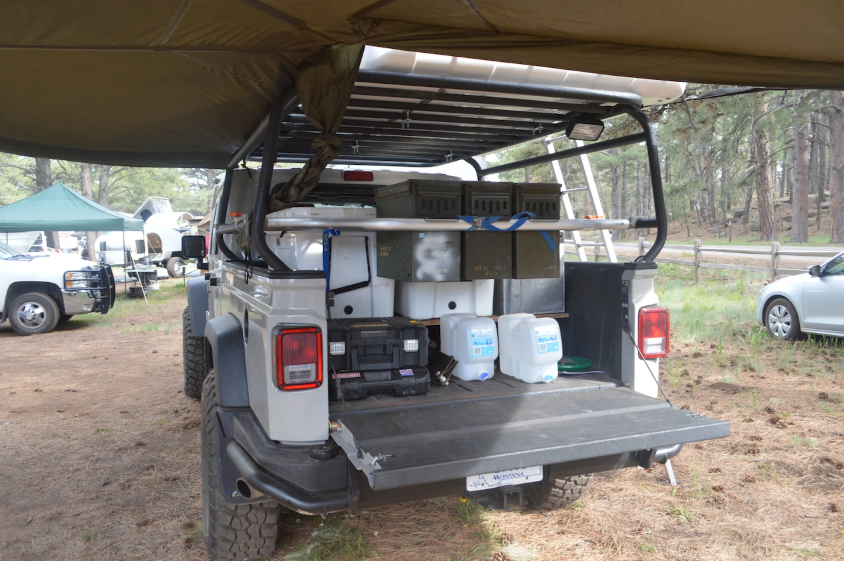 Under the awning of this Jeep pickup camper
