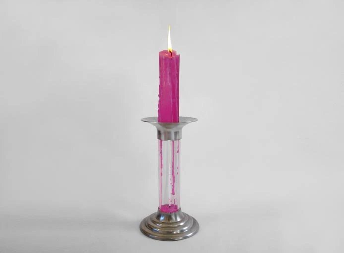 As the candle burns at the top, the melted wax collects at the bottom