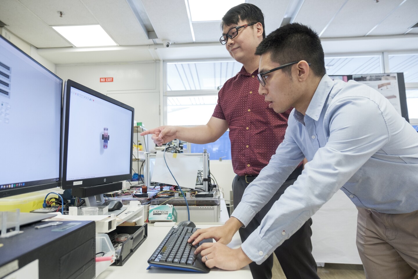 NTU Assistant Professor Lum Guo Zhan and co-author Yang Zilin controlling the miniature robots using magnetic fields