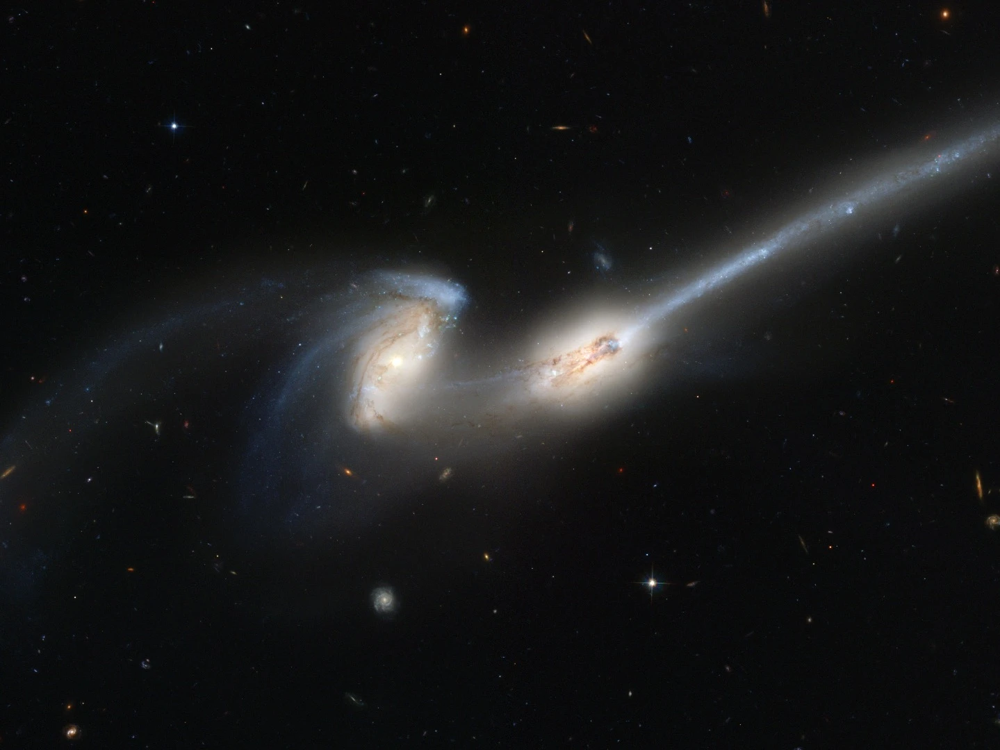 Located 300 million light-years away in the constellation Coma Berenices, the colliding galaxies have been nicknamed "The Mice" because of the long tails of stars and gas emanating from each galaxy. Otherwise known as NGC 4676, the pair will eventually merge into a single giant galaxy