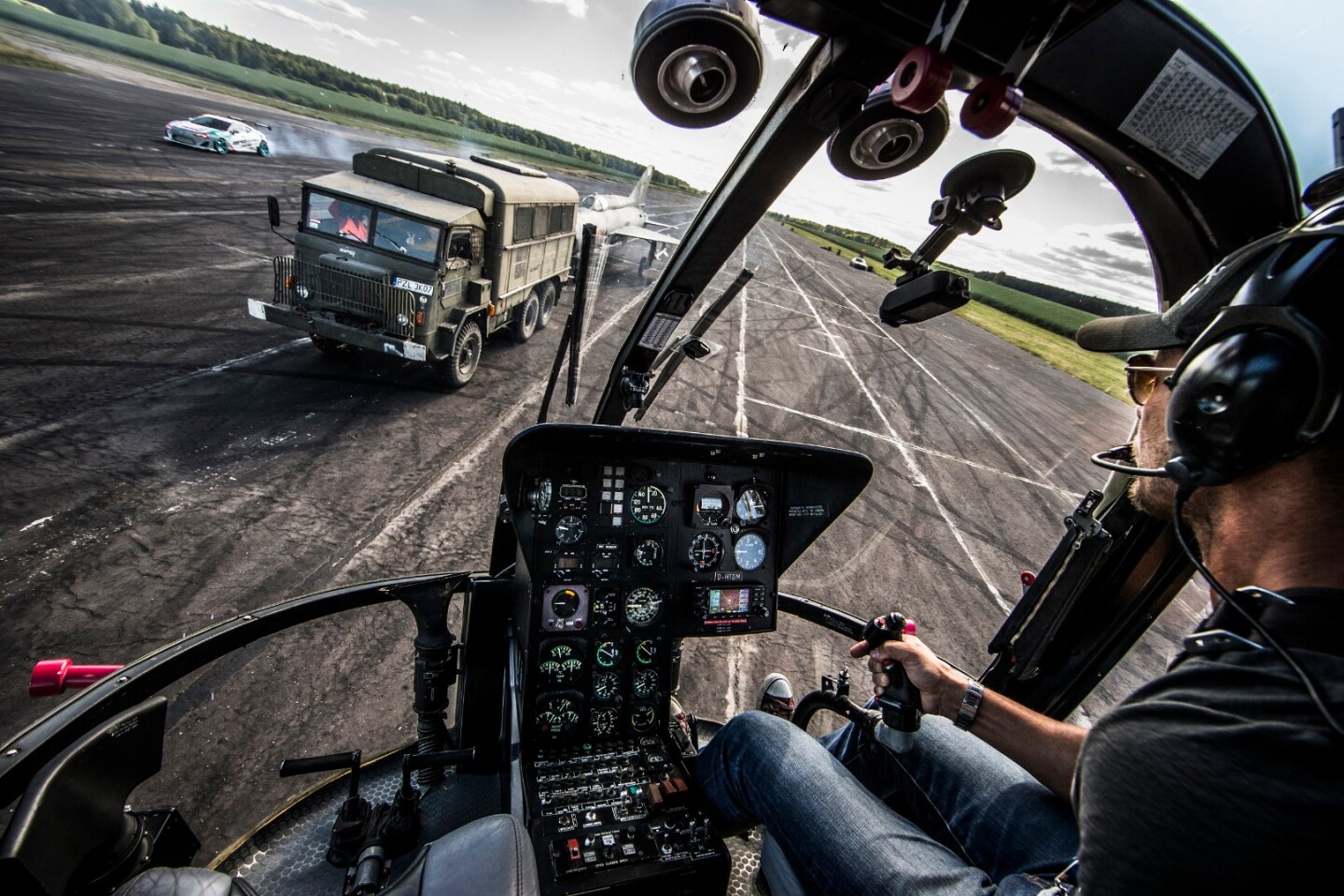 Baumgartner and Przygoński circled a military vehicle towing a plane during the stunt