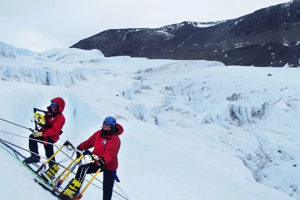Christina Carr, left, and Jessica Badgeley collect radar data to map the pathway of salty water that connects Blood Falls to the source of water underneath the glacier
