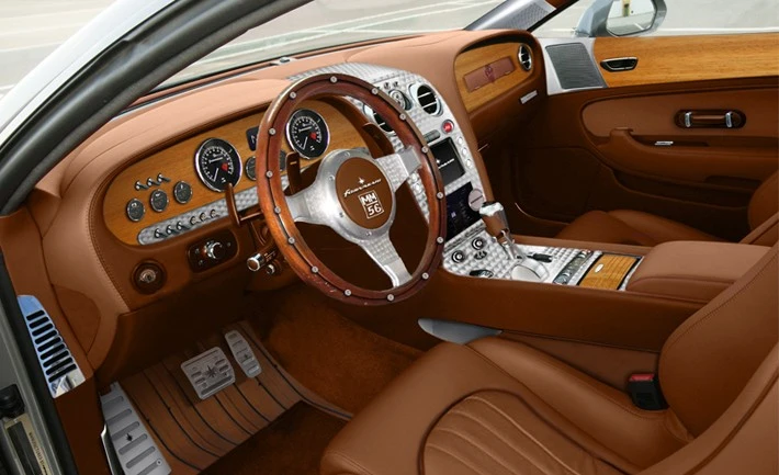 Hand finished interior, with aluminum and leather accents is frequented with old world wood inserts, reminiscent of the 1960s