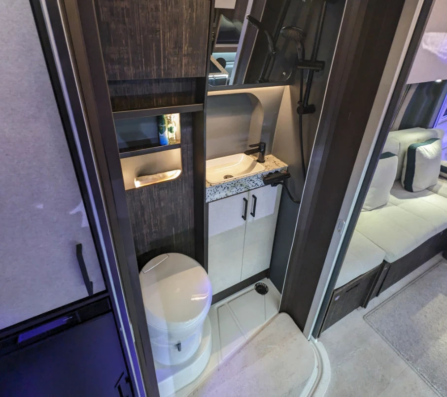 The Endeavor EV's bathroom has a different look and materials but relies on roller door expansion, just like the ICE Endeavor's bathroom