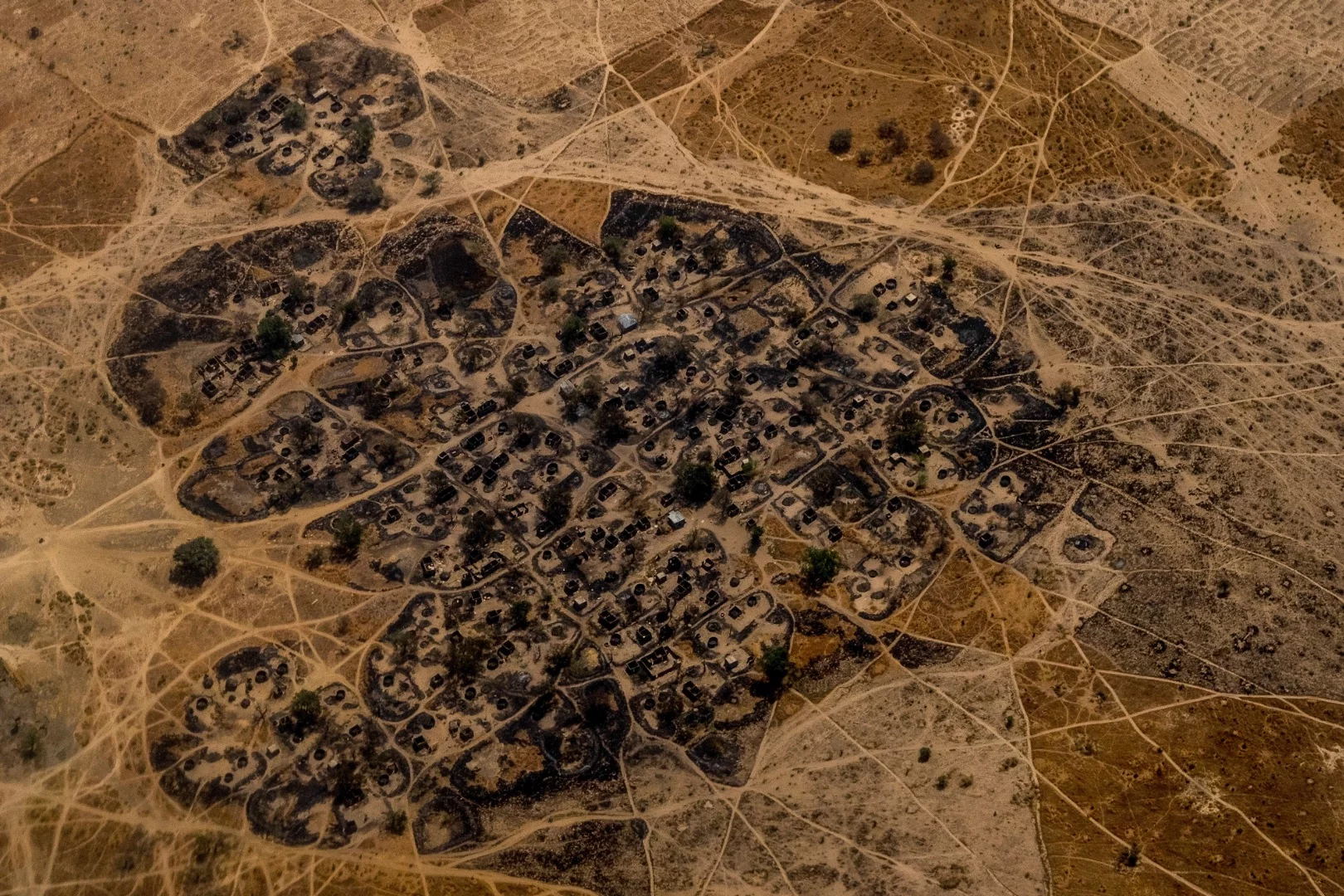 A burned Nigerian village seen from a United Nations helicopter flying between Maiduguri and Monguno. Villages have been razed and burned by both Boko Haram and the Nigerian Military throughout the region