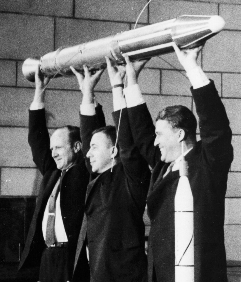 From left to right, Dr. William Pickering, Dr. James Van Allen, Dr. Wernher von Braun are pictured holding a scale model of Explorer 1 aloft during the post launch press conference