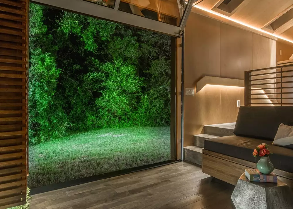 The Orchid Tiny House features a large garage-style lifting door