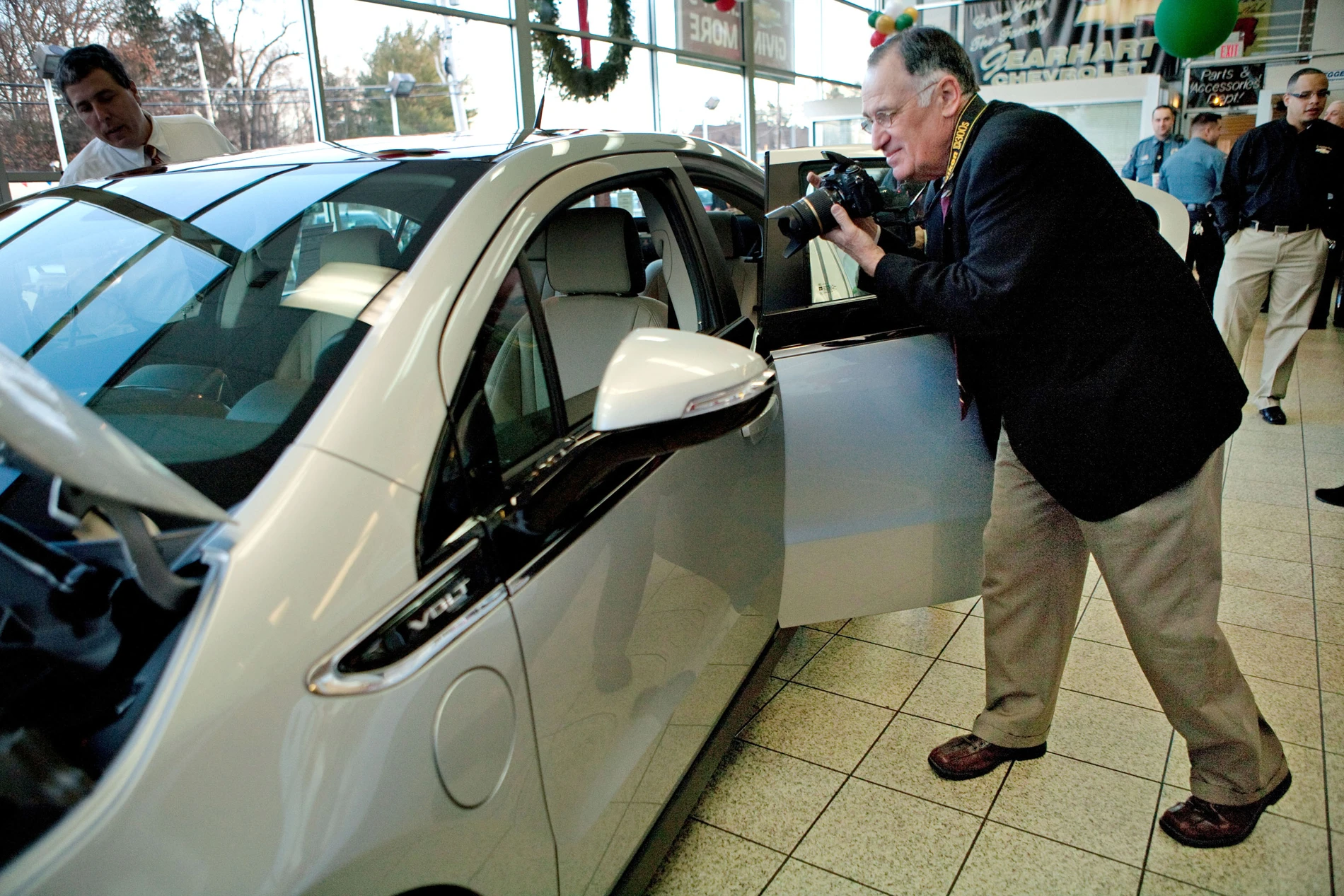 Jeffrey Kaffee takes pictures of his new Chevrolet Volt - presumably for insurance purposes or something (Image: Emile Wamsteker for Chevrolet)