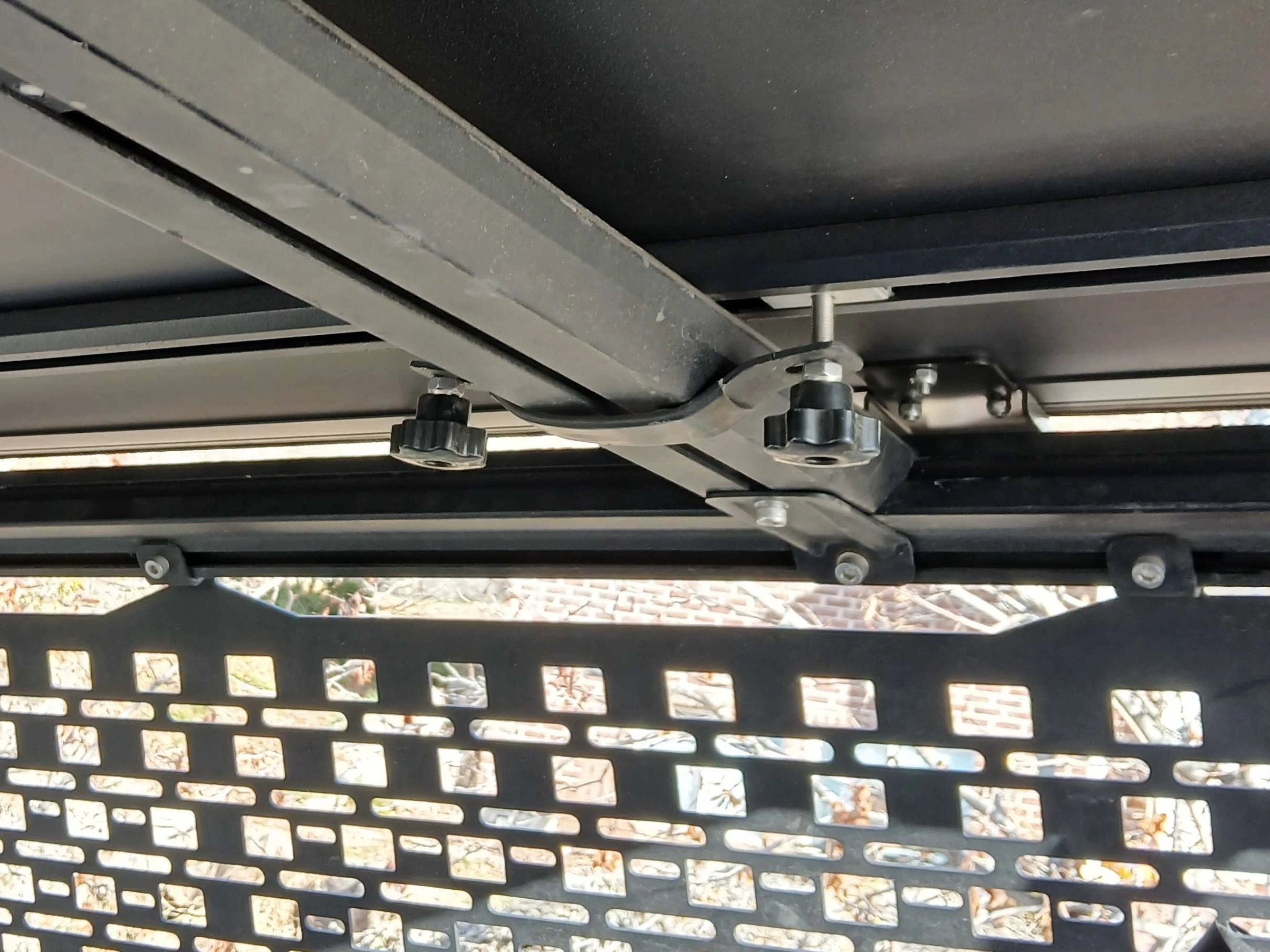 We attached the four brackets with anti-slip nut first, quick-release hand nut second because the anti-slip nut would have taken up the entire bolt if we'd done it the opposite way