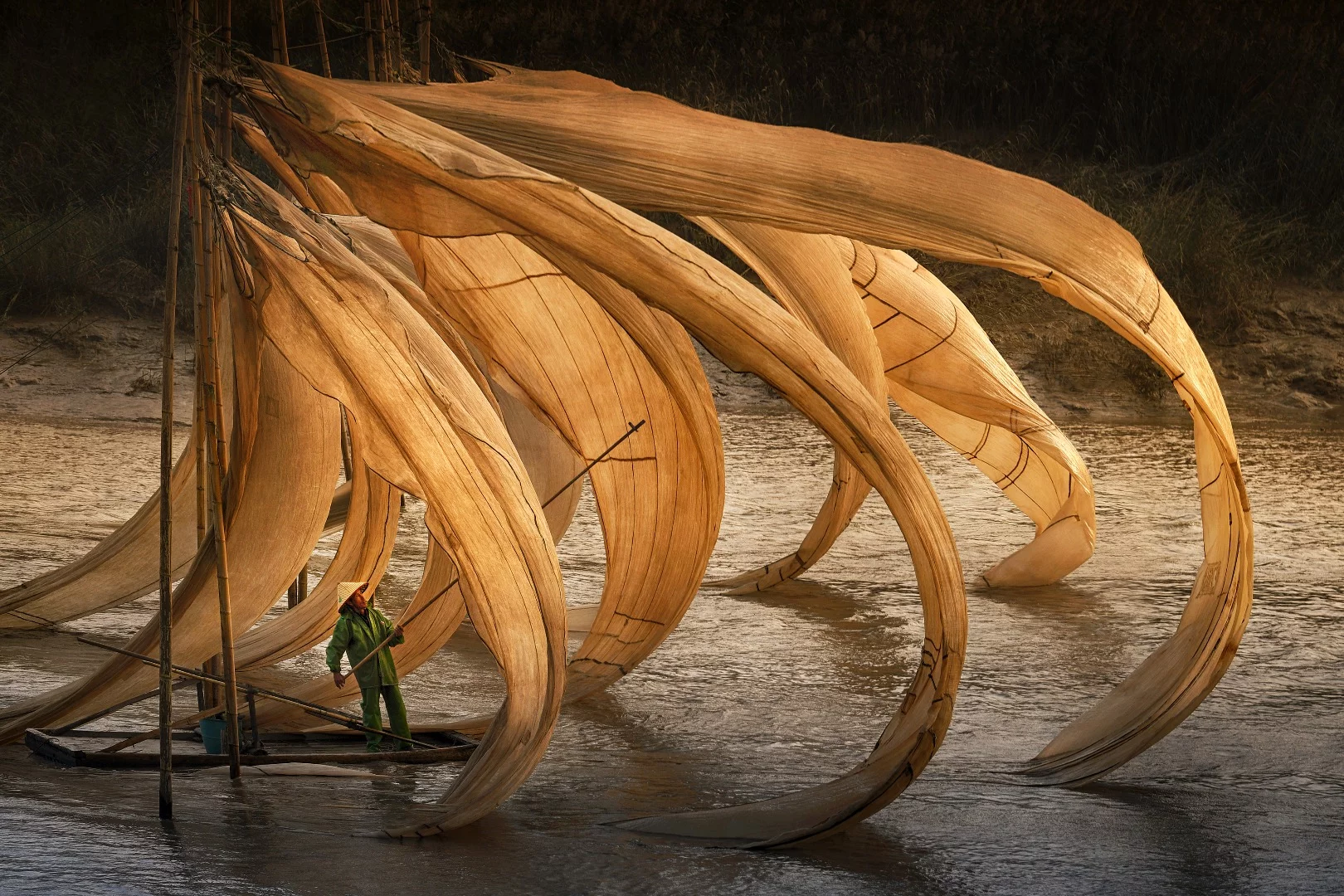 Fisherman at work on the river during sunset hour in Xiapu county, China