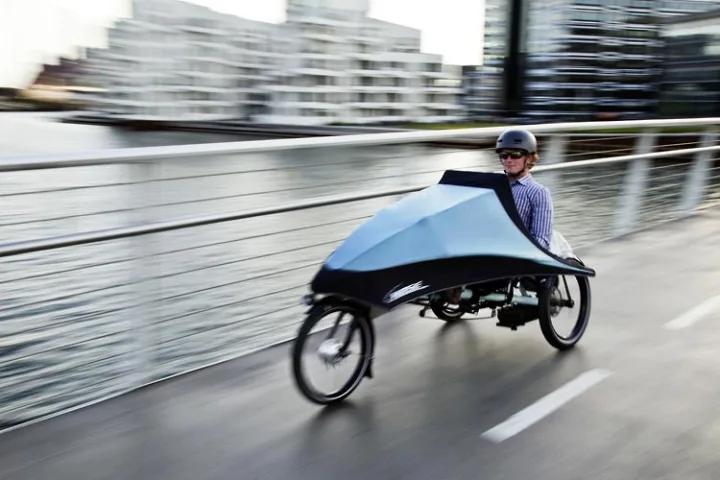 Hase Bikes' KLIMAX tricycle features a detachable folding fairing, allowing users to add weather protection as needed