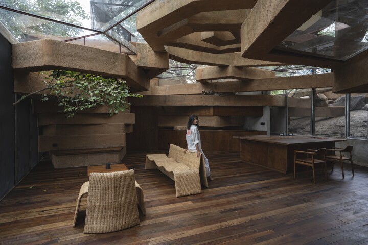 Chuzhi's interior is arranged around a central open area which contains a kitchen, dining, and living room