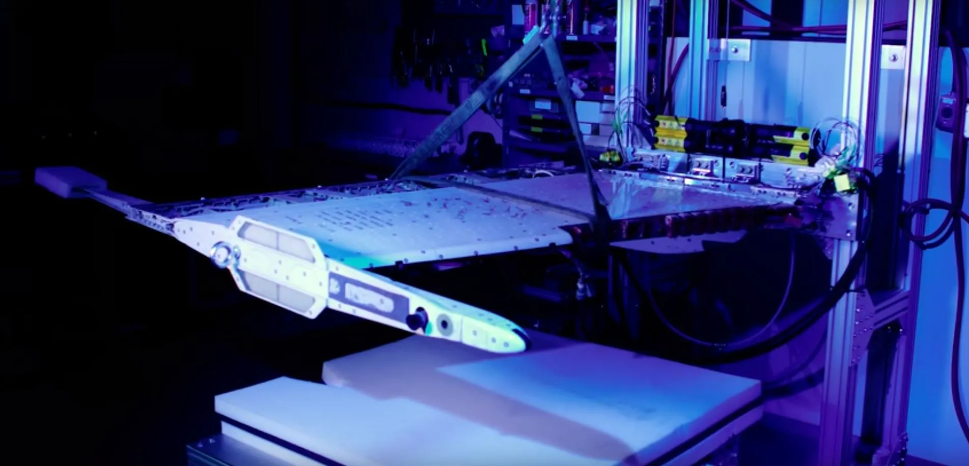 An F-18 wing section with a memory alloy actuator installed undergoing testing
