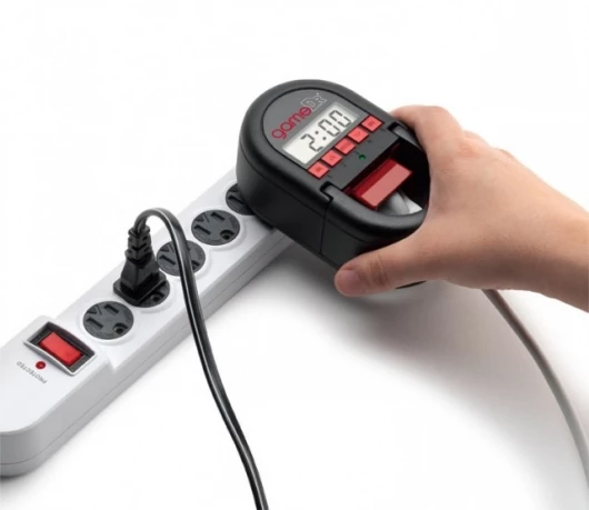 Tabs lock over the console power plug to prevent it being pulled out and a four digit code stops the timer being adjusted
