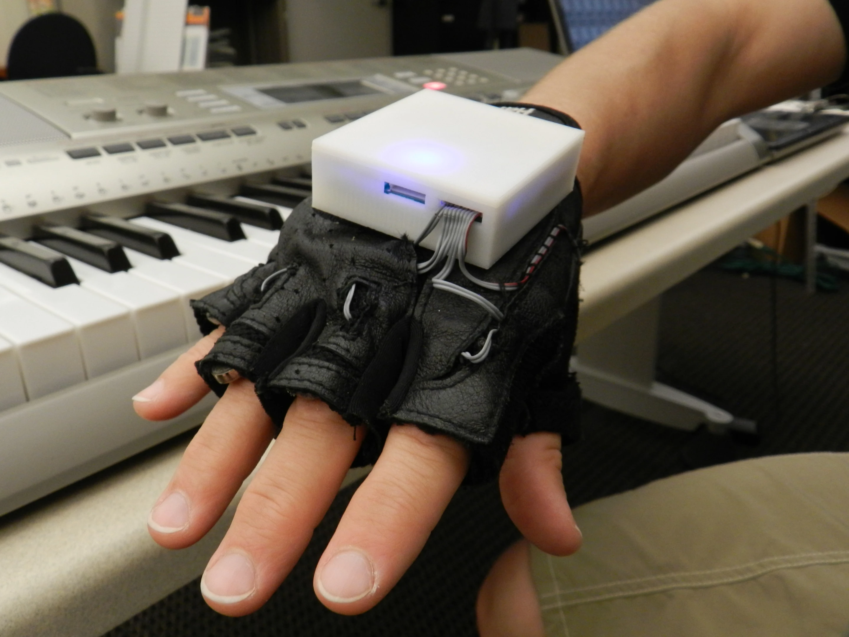 The Mobile Music Touch (MMT) system comprises a vibrating glove that connects wirelessly to a computer, MP3 player or smartphone