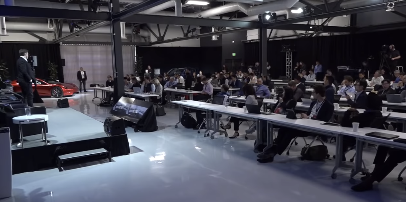Elon Musk addresses the room