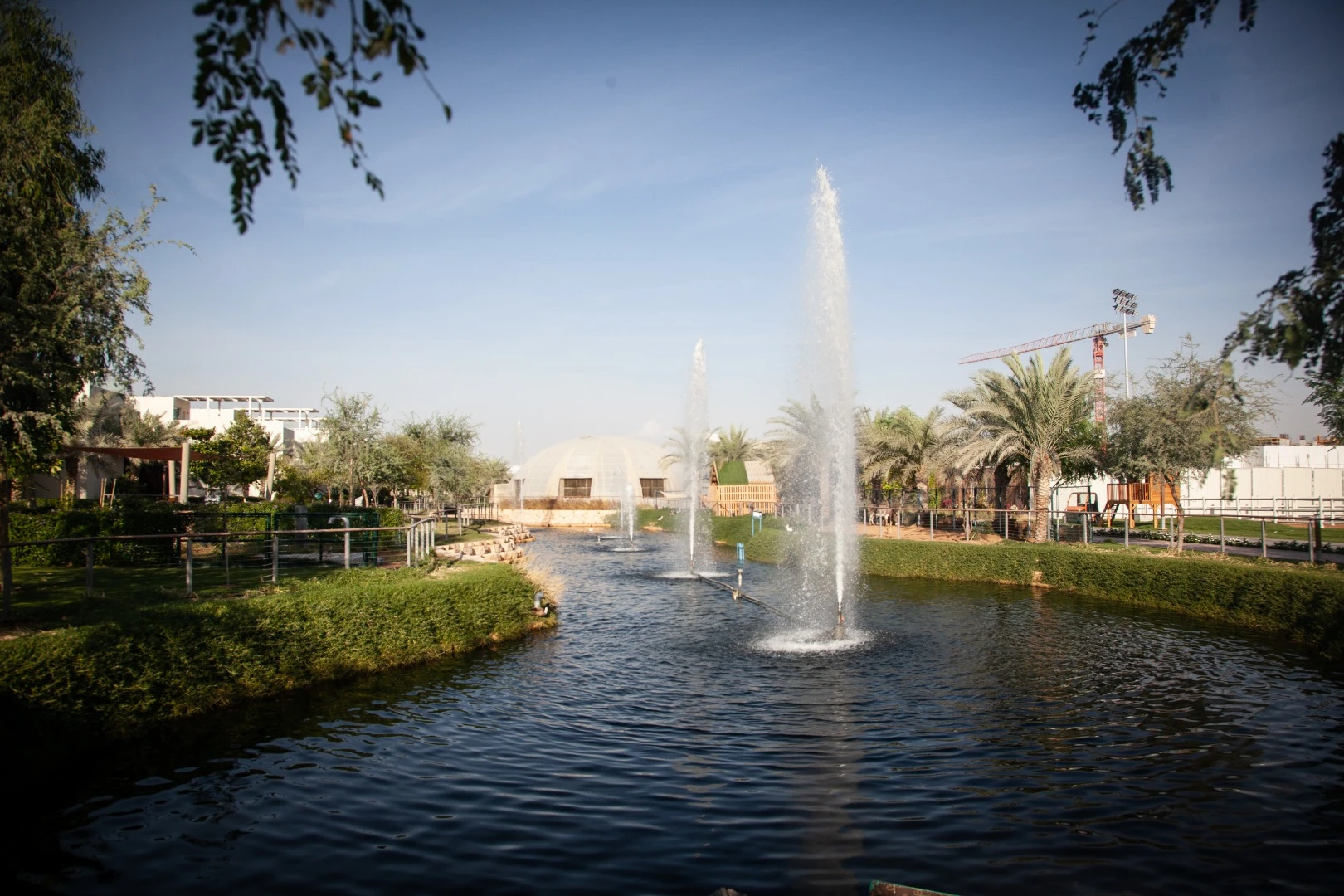A waterway winds through the Dubai Sustainable City as part of its "Central Green Spine"
