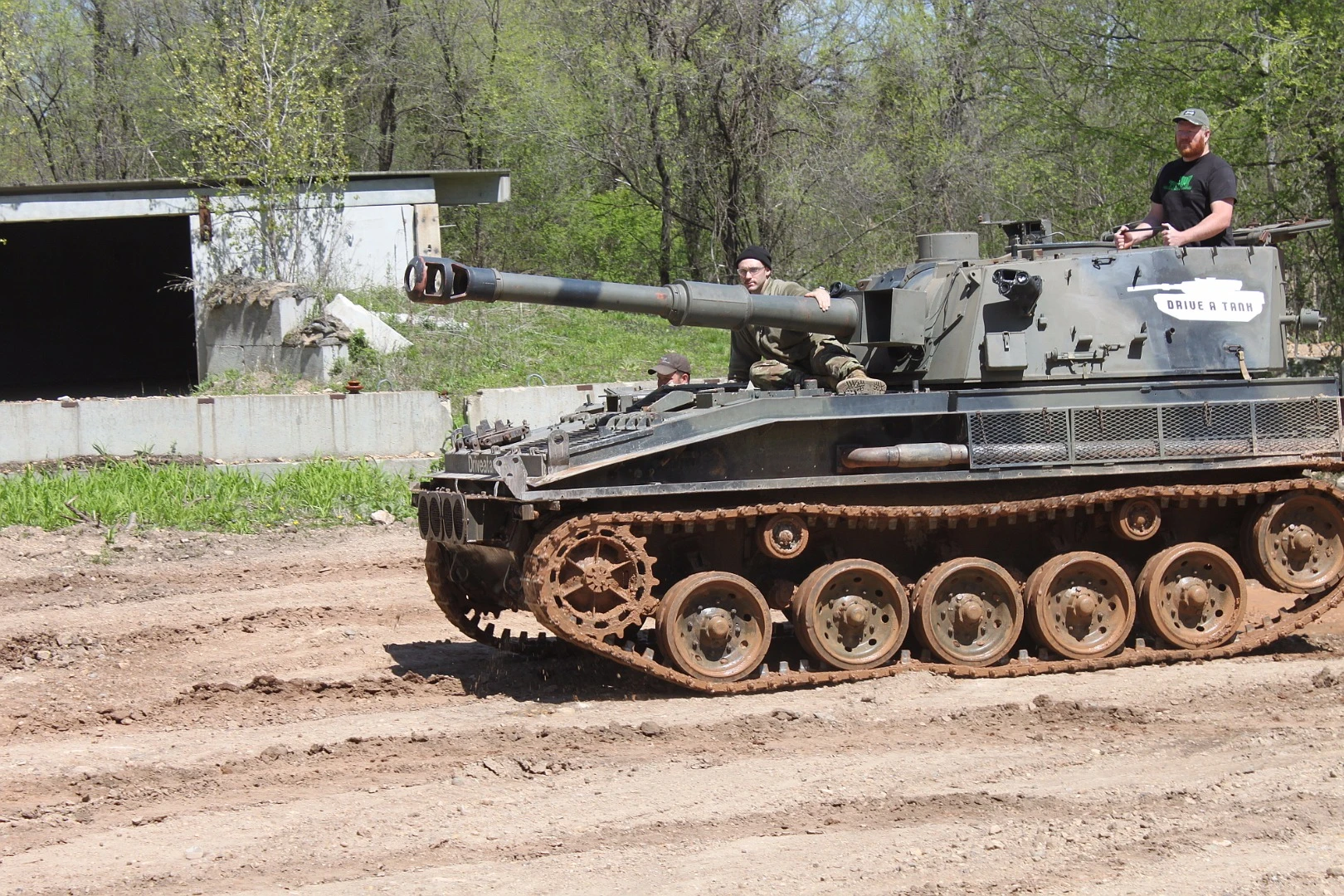 As journalist Tim Esterdahl brings the Abbot FV433 in to park, the author Aaron Turpen sits atop the SPG trying not to grin like a total idiot