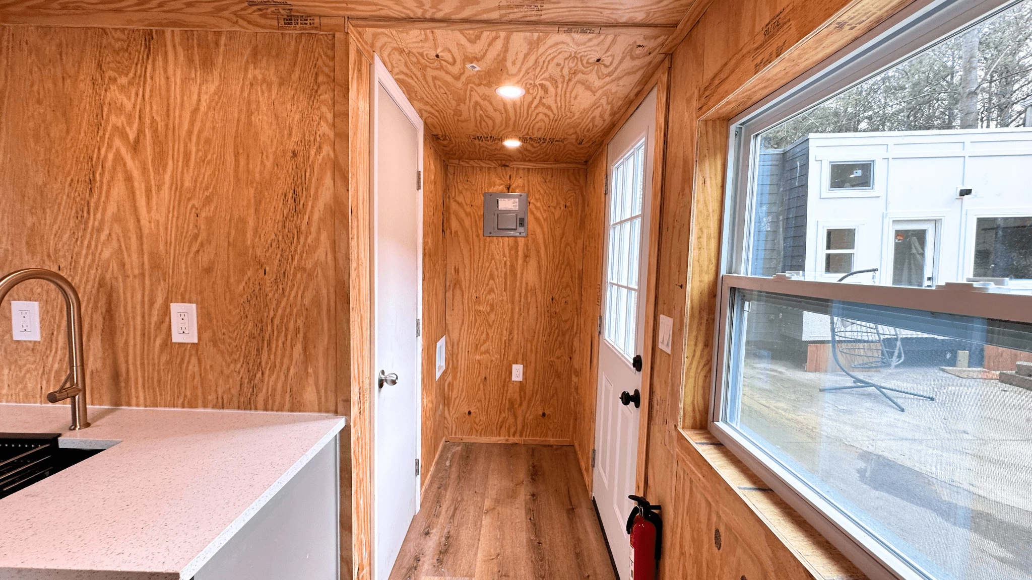 The Element's downstairs contains a hallway, a main living/kitchen area, and a bathroom