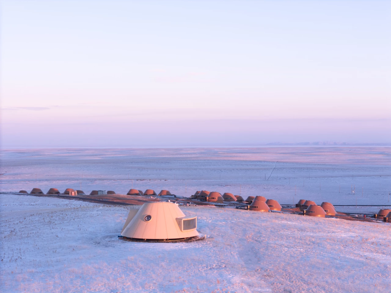 The prototype cabin stands apart on a nearby hilltop