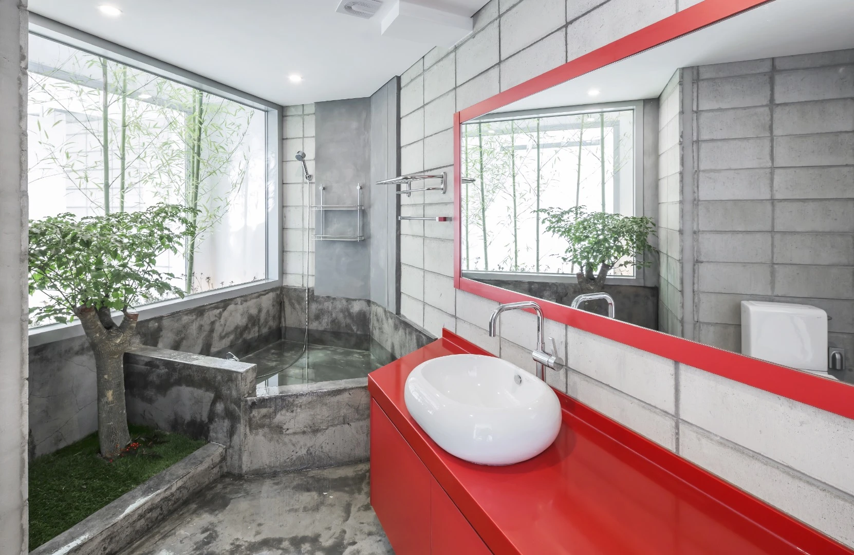The Flying House's bathroom includes a concrete bath and a small tree