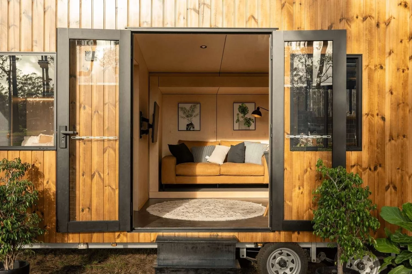 The Luna tiny house is entered through double glass doors, which really help open up the home to the outside