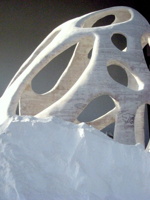 Sand supports the structure while it solidifies and is then brushed away