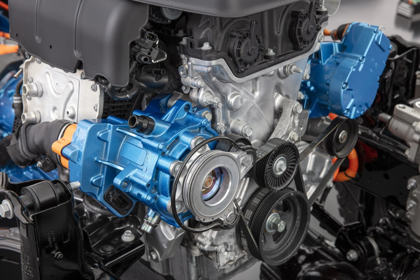 The 2021 Jeep Wrangler 4xe front motor, which acts as both starter and alternator, connecting directly to the four-cylinder engine's crankshaft