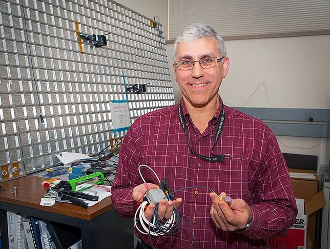 Eric Madaras holds one of the Distributed Impact Detection System units (Photo: NASA)