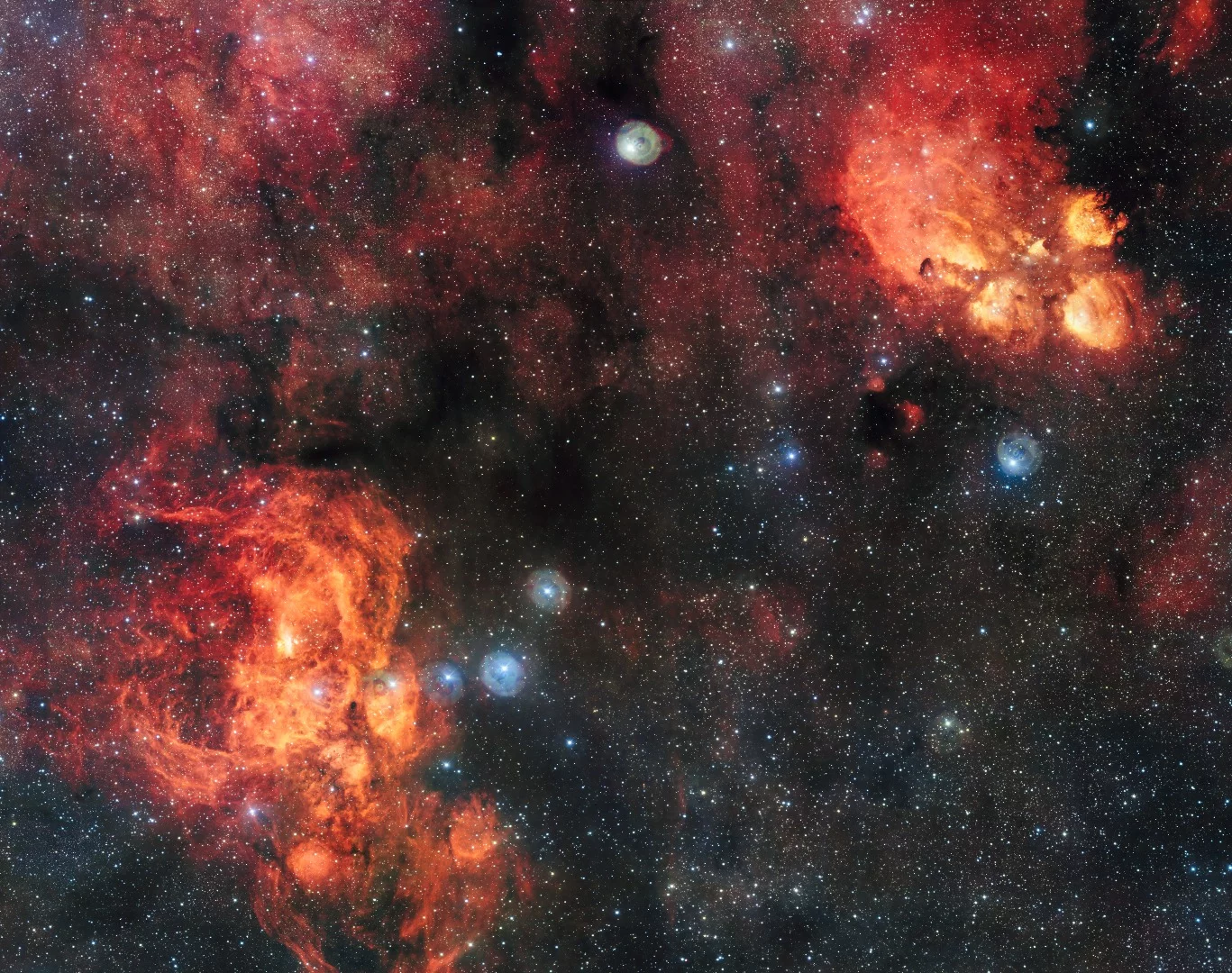 Though they appear side by side in the image, the Cat's Paw Nebula (top right) is far closer at 5,500 light-years, than the Lobster Nebula (bottom left), which sits roughly 8,000 light-years from Earth