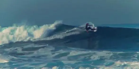 The snowboard bottom doesn't appear to hurt the surfing