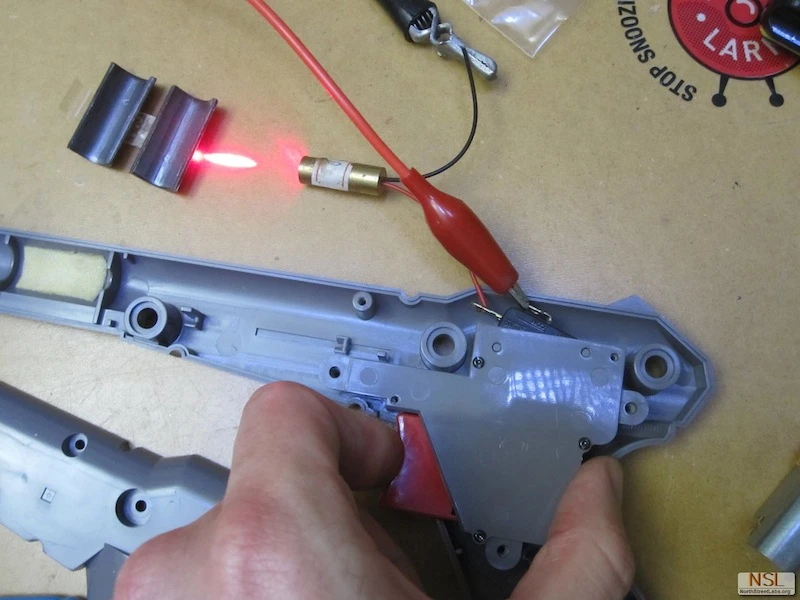 The basic components used to make the NES Zapper Laser included batteries, a 445 nm diode, lens, key switch and heat-sink